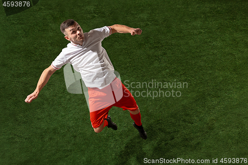 Image of Football player tackling ball over green grass background