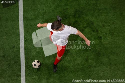 Image of Football player tackling ball over green grass background