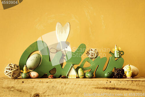 Image of Word Easter in german language with easter bunny eggs and chicks