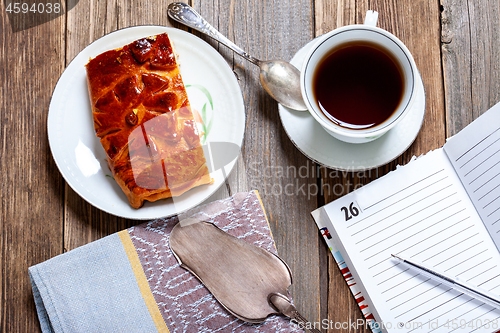 Image of Tea, cake and diary. Still life