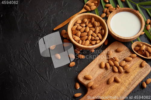Image of Close up of Almonds in wooden bowl and almond milk