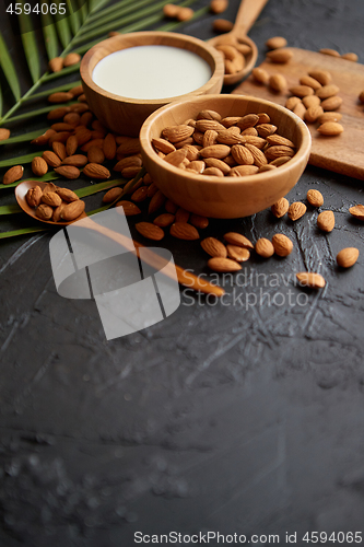 Image of Close up of Almonds in wooden bowl and almond milk