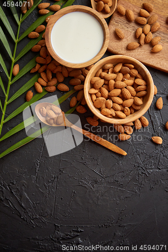 Image of Close up of Almonds in wooden bowl and almond milk