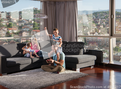 Image of Happy family playing a video game