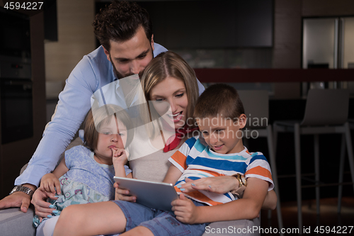 Image of happy young couple spending time with kids