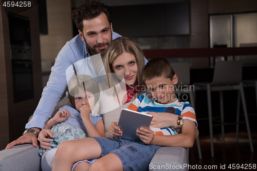 Image of happy young couple spending time with kids