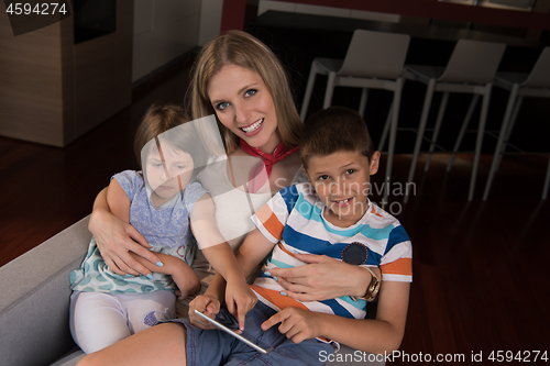 Image of happy young mother spending time with kids