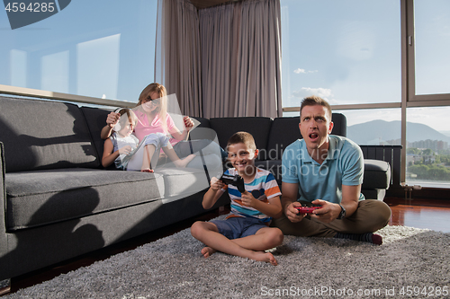 Image of Happy family playing a video game