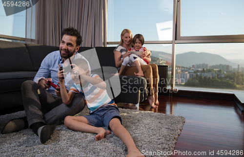 Image of Happy family playing a video game
