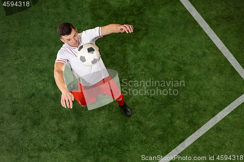 Image of Football player tackling ball over green grass background