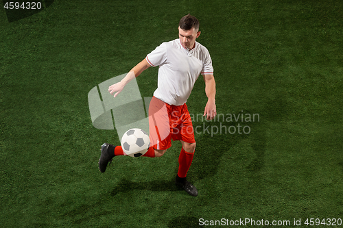 Image of Football player tackling ball over green grass background