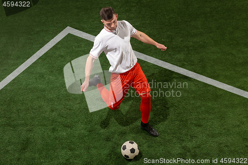 Image of Football player tackling ball over green grass background