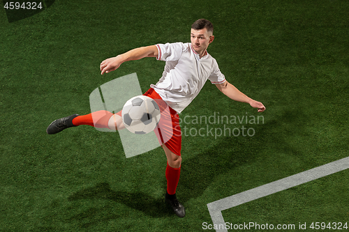 Image of Football player tackling ball over green grass background