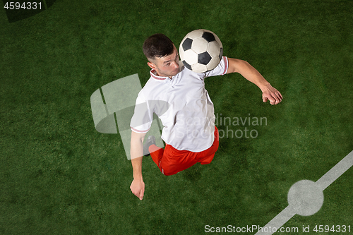 Image of Football player tackling ball over green grass background