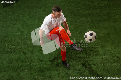 Image of Football player tackling ball over green grass background