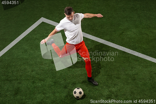 Image of Football player tackling ball over green grass background