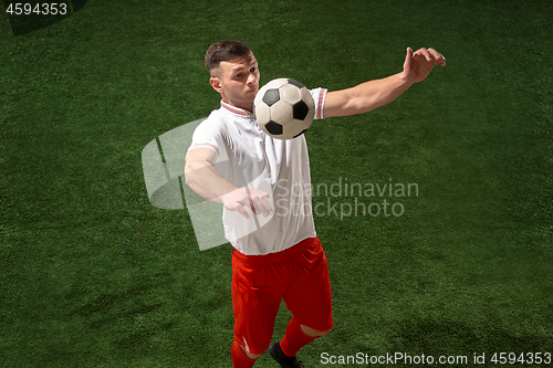 Image of Football player tackling ball over green grass background