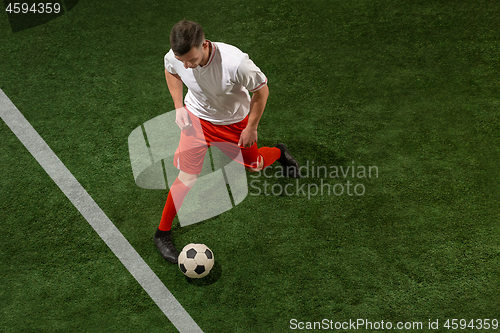 Image of Football player tackling ball over green grass background