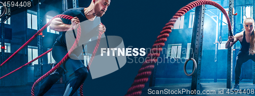 Image of Men with battle rope battle ropes exercise in the fitness gym.