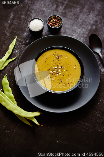 Image of Creamy soup with green pea in a ceramic white plate