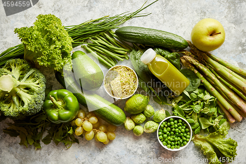 Image of Green antioxidant organic vegetables, fruits and herbs placed on gray stone