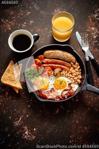 Image of Delicious english breakfast in iron cooking pan