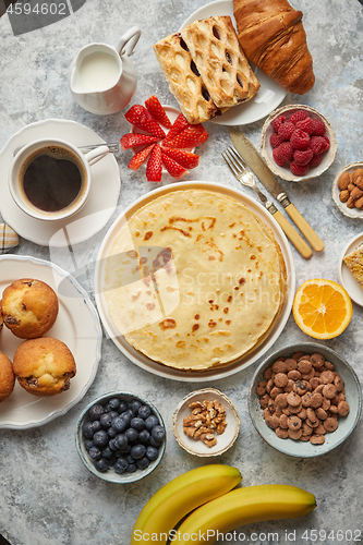 Image of Various breakfast ingredients placed on stone table