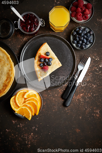 Image of Tasety homemade pancake on black ceramic plate.