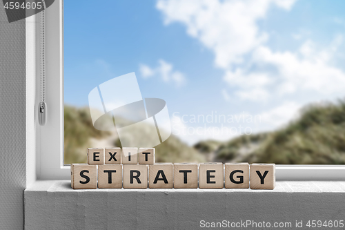 Image of Exit strategy sign in a window with a view