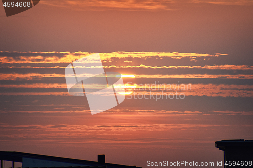 Image of Red sunset over rooftop silhouette