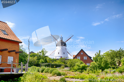 Image of Old mill in a green garden in the summertime