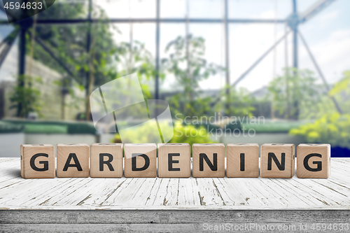 Image of Gardening sign in a green house on a wooden