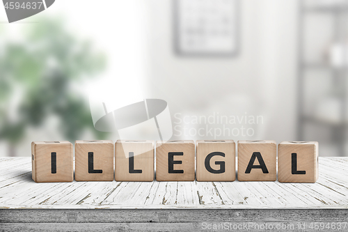 Image of Illegal message on a wooden desk