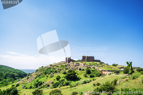 Image of Ruin of a castle on the top af o green hill