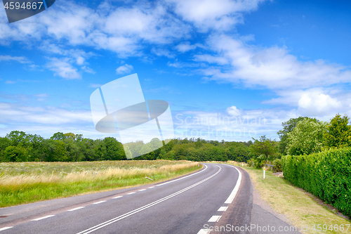 Image of Curvy road under a blue sky in the summer