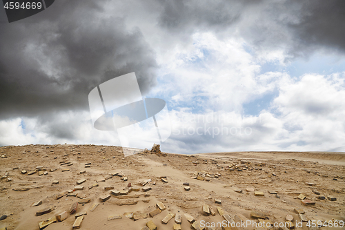 Image of Bricks in a dry desert in cloudy weather