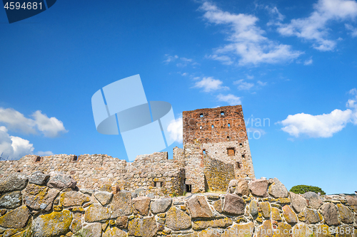 Image of Castle ruin rising up behind an old brick wall