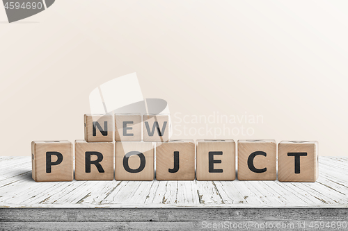 Image of New project message on a wooden table