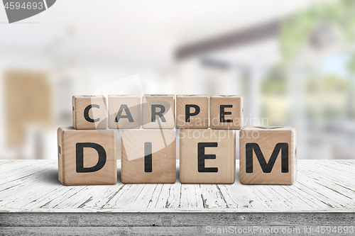 Image of Carpe diem seize the day sign on a table
