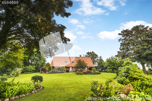 Image of Red brick house in a beautiful garden