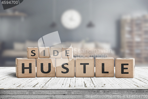 Image of Side hustle sign on a plank table