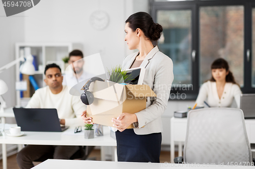 Image of female office worker with box of personal stuff