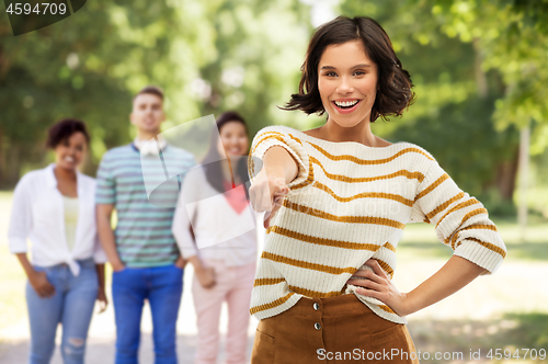 Image of happy woman pointing finger to you at summer park