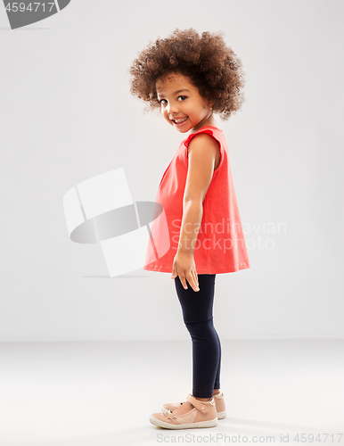 Image of happy little african american girl over grey