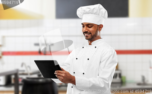 Image of indian chef with tablet pc at restaurant kitchen