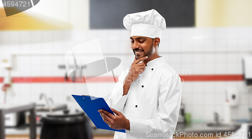 Image of indian chef with clipboard at restaurant kitchen