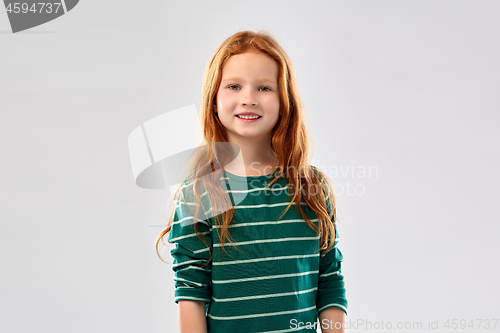 Image of smiling red haired girl in striped shirt