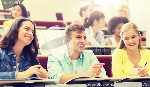 Image of group of students with notebooks in lecture hall