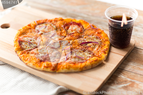 Image of close up of homemade pizza with cola on table