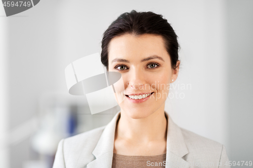 Image of portrait of happy smiling young businesswoman